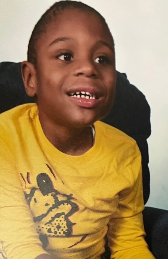 Kohen Hall smiling in a bright yellow shirt